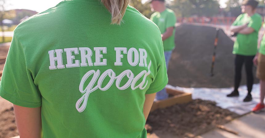 Sprouts volunteers wearing "Here for good" tshirts.