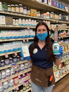 Sprouts team member standing in vitamin aisle