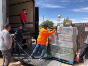 People unloading donations off semi truck