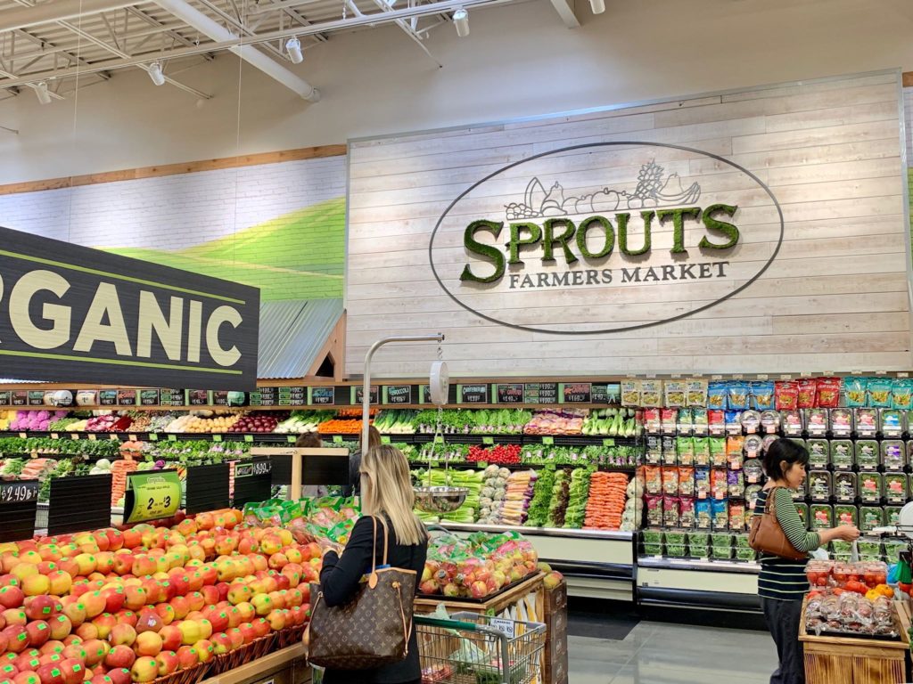 Produce department of a grocery store with Sprouts sign on wall