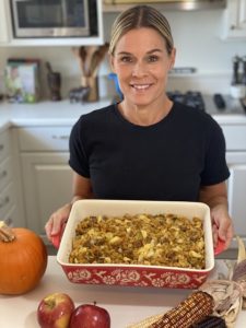 Cat Cora with baking dish of thanksgiving stuffing