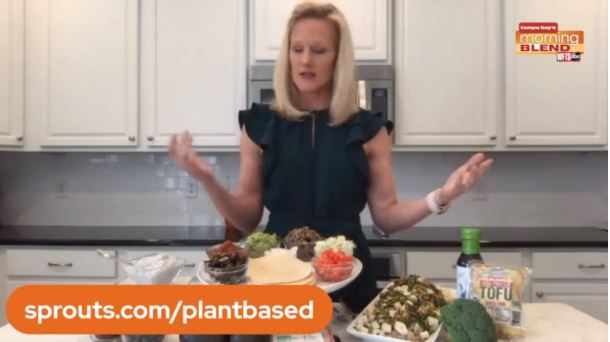 TV Segment set of Abigail in kitchen with plant-based dishes in front of her.
