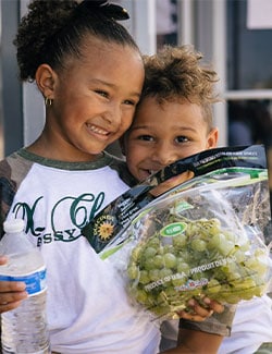kids holding free grapes
